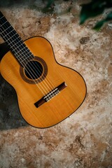 Still life of a guitar nestled on a cushioned seat, combining musical presence with a soft, calm setting.