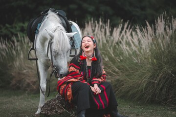 Joyful Young Woman Laughing with Elegant White Horse Outdoors