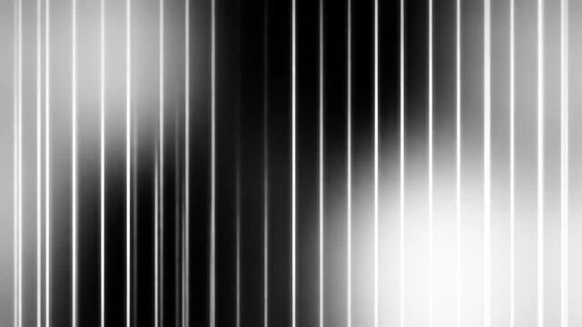 Abstract image featuring vertical lines in varying shades of gray, creating a textured, rhythmic visual pattern.
