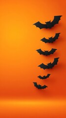 Naklejka premium Modern vector illustration of bat silhouettes flying on orange background