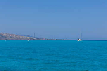 Seascape with blue sky and white yachts in the distance