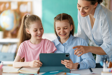 Happy kids and teacher at school