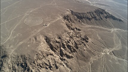 Aerial View of Arid Landscape Featuring Geological Formations and Ancient Earthworks in Remote Region