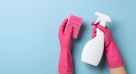 Hands in pink gloves holding a cleaning spray bottle and a sponge.