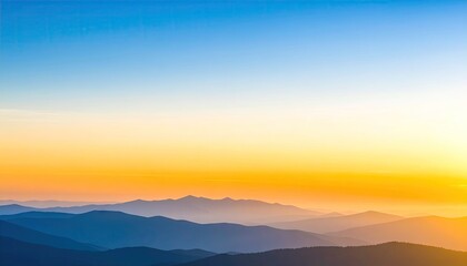 Obraz premium Panoramic Landscape Of Silhouetted Mountains And Hazy Horizon During Sunset With Blue And Orange Gradient