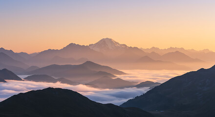 Majestic mountain landscape with layered peaks rising above a sea of fog during a beautiful golden hour sunrise.