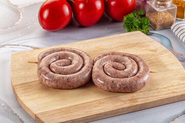 Raw meat pork and beef swirl sausages
