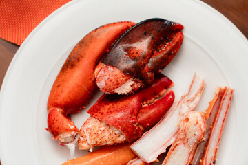 Close-Up of Fresh Lobster Claws and Crab Legs on a White Plate