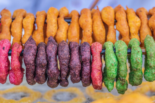Traditional Peruvian picarones fried dough street food in colorful display