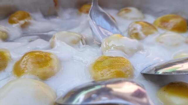 A delicious, mouth-watering close-up shot of "Kue Bugis Telanjang," a popular traditional Indonesian sweet