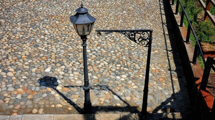 Ornate lamppost on a cobblestone street.
