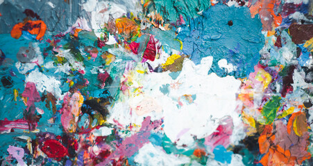A painting with a lot of colors and paint splatters. The painting is a mix of different colors and textures, with some areas being more vibrant than others. The overall mood of the painting is chaotic