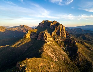 Obraz premium Mountain peak, golden light, aerial view