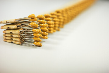  Yellow ceramic disc capacitors aligned in a diagonal row