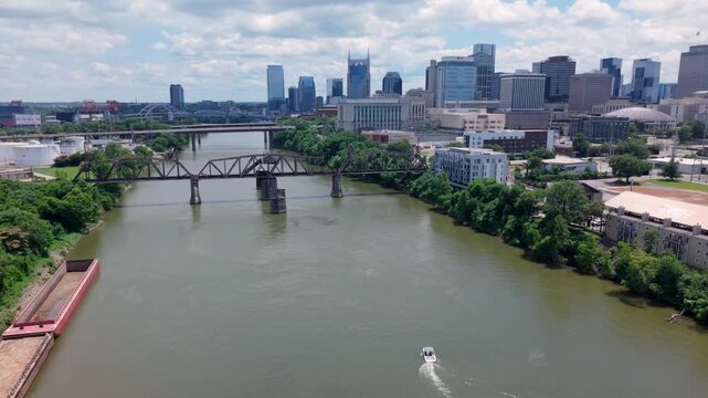 Aerial Flyover Of A Boat And Bridges On The Cumberland River In Downtown Nashville, Tennessee, USA.