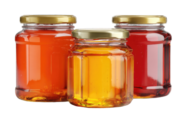 Three glass jars, filled with colorful preserves, gold lids