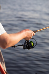 fisherman fishing, Fishing rod, spinning, fisherman against blue sky