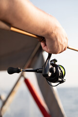 fisherman fishing, Fishing rod, spinning, fisherman against blue sky