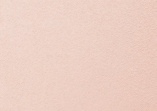 Peach textured wall background with small granules