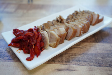 Korean Boiled Pork with Spicy Pollack Salad on White Plate