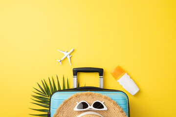 Flat lay composition featuring travel essentials including a suitcase, sunglasses, and tropical...