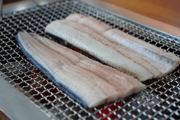 Eel Fillets Grilling on Metal Grid