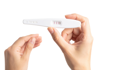 positive pregnancy on test strip holded in hand pregnancy test strip, awareness concept 