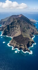 Obraz premium Volcanic island in the middle of the ocean, aerial view