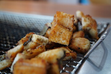 Grilled Eel Pieces in Metal Basket
