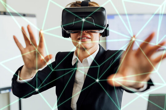Businesswoman wearing smart glasses working on transparent screen