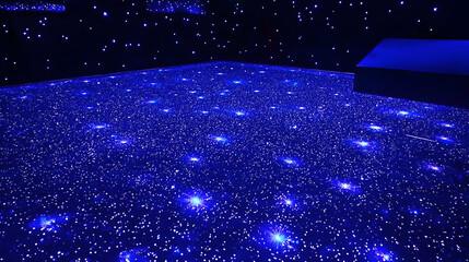 Dark blue floor with numerous tiny blue lights creating a starry night effect.  A slightly elevated dark object is visible in the upper right