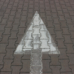 Road marking in the form of an arrow on textured street tiles square stock image