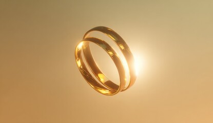 Two golden wedding rings float in soft light