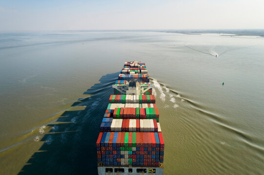 Container ship heading towards port of Antwerp in Netherlands
