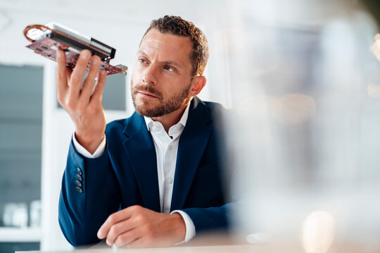 Businessman looking at heating module in office