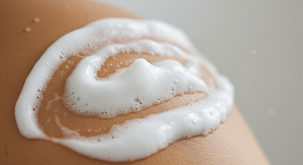 Creamy cleanser or moisturizer foam on soft skin at a relaxing spa session