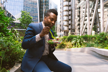 Businessman having salad at office park