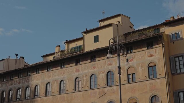 Famous Palazzo dell Antella with frescoed facade located on Piazza Santa Croce on sunny day. Architectural monument luxury palace with mosaics on town square