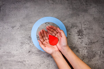 Woman Hands Holding Red Paper Drop Inside Blue Diabetes Circle On Concrete Background