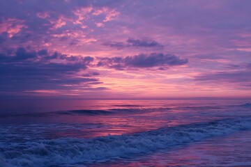 Fototapeta premium Dynamic pink and purple sunrise over ocean waves 
