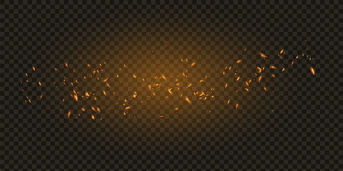 Flame of fire with sparks on a black background. The texture of the fiery storm. The fiery sparks of Boke's lights flash, a shot of a flying spark in the air.over a dark night © kume111000