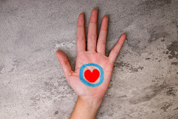 Open Hand With Red Heart And Blue Circle Painted On Palm Symbolizing Diabetes Awareness And Support, Isolated On Grey Texture Background