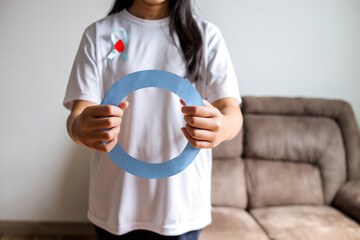 Close-up Of Woman Hands Showing Diabetes Sign, Ribbon On Chest In Focus