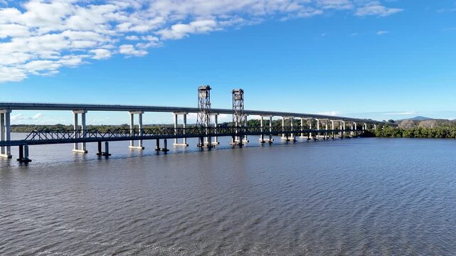 Drone captures Harwood Bridge spanning Australia&rsquo;s glistening Clarence River in bright daylight.