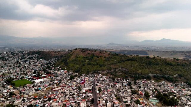 lateral drone shot of urban decay in mexico city in a volcano