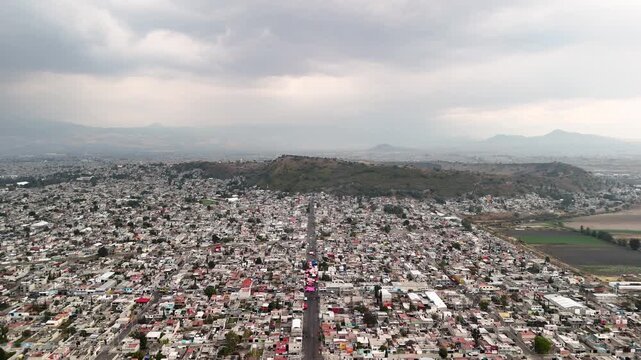 backwards drone shot of urban poverty in chalco