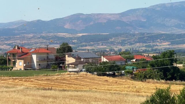 Small wind tornado dust devil Greece rural countryside village outdoor clear sky