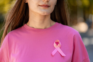 Woman wearing pink ribbon for breast cancer awareness supporting charity