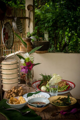 Shrimp paste chili dip, steamed rice, stir-fried morning glory with chili paste and omelet are placed on the dining table. Retro Thai style image.