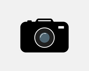 Flat design vector illustration of a black digital camera icon with lens and white background